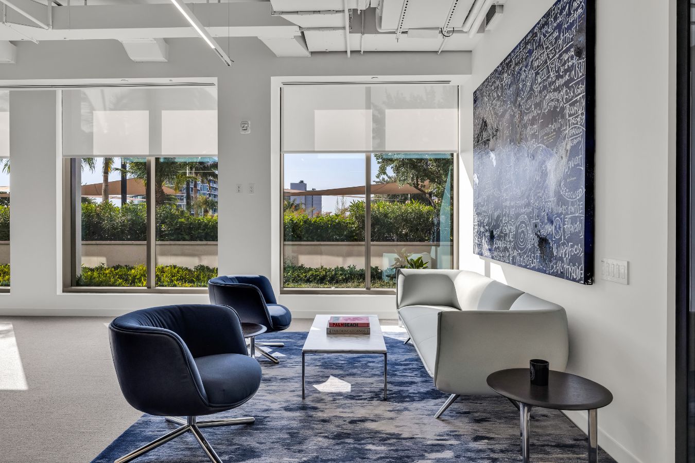 One Flagler - Navy blue velvet swivel chairs and blue abstract rug - BHouse Design Florida